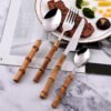 MZCJ-0006   Stainless steel tableware set - knives, forks and spoons - suitable for both hotel and home dining. The handles are made of natural bamboo, providing both anti-slip properties and environmental friendliness